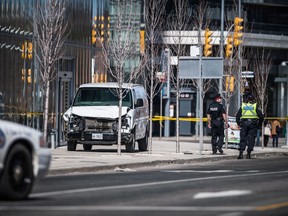 Police are seen near a damaged van in Toronto after a van mounted a sidewalk crashing into a number of pedestrians on April 23, 2018. Monday's deadly rental van rampage in Toronto shows how quickly a vehicle can be turned into a weapon, but rental agencies are finding few clear options to prevent their property from involvement in such violent acts.The urgency to find solutions is increasing, however.
