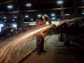 Fabricator Mike Caldarino uses a grinder on a steel stairs being manufactured for a high school in Redmond, Wash., at George Third & Son Steel Fabricators and Erectors, in Burnaby, B.C., on Thursday March 29, 2018. Manufacturing sales increased 1.9% to $55.8 billion in February, following two consecutive monthly decreases. The growth was due mainly to higher sales in the transportation equipment industry.