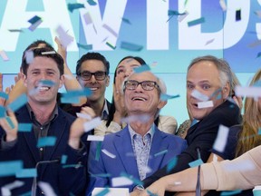 Herschel Segal, center, and David Segal, left, co-founders of DavidsTea, celebrate the company's IPO with Sylvain Toutant, right, President and CEO, at the Nasdaq MarketSite in New York on June 5, 2015. The board of DavidsTea is fighting back against the retail co-founder's attempt to replace them with his dissident slate of nominees. The Montreal-based company says Herschel Segal is trying to gain control of the board without paying a premium by pushing the election of seven director nominees at its annual meeting June 14.