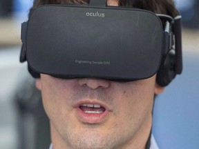 Prime Minister Justin Trudeau plays a virtual reality video game during a visit to video game maker Ubisoft, Thursday, February 25, 2016 in Montreal. A world-renowned video game company is setting up shop in Winnipeg. Ubisoft, which is known for Assassin's Creed and Far Cry, announced today that it is opening an office in the city.