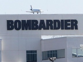 A plane comes in for a landing at a Bombardier plant in Montreal, Thursday, May 14, 2015.