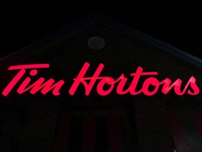 A Tim Hortons restaurant sign is shown in Newcastle, Ont. on Sunday Feb. 11, 2018. A group representing about half of the country's Tim Hortons franchisees is vowing "to do everything in our power" to assist a prominent member whose license renewal was denied amid his ongoing tensions with the fast food giant.