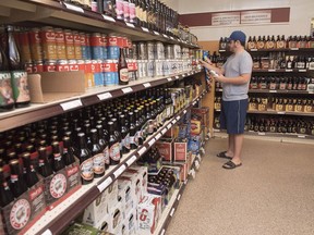 Customer Matt Oliver shops in the craft beer section of the NB Liquor store attached to the old Fredericton Railway Station in Fredericton, N.B., on Friday, June 16, 2017. A Supreme Court of Canada ruling that provinces have the right, with limits, to enact laws that restrict interprovincial commerce represents a "missed opportunity" to free up trade within Canada, industry observers say.THE CANADIAN PRESS/Stephen MacGillivray