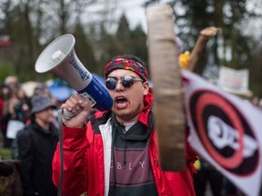 Cedar George-Parker addresses the crowd as protesters opposed to the Kinder Morgan Trans Mountain pipeline extension defy a court order and block an entrance to the company's property, in Burnaby, B.C., on April 7, 2018.