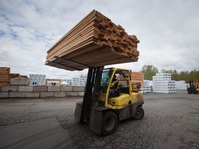 A worker uses a forklift to move lumber at the Partap Forest Products mill in Maple Ridge, B.C., on Tuesday April 25, 2017. One year after the United States imposed stiff import duties on Canadian softwood strong demand for wood and record market prices mean it's American consumers and not Canadian producers feeling the pinch.THE CANADIAN PRESS/Darryl Dyck
