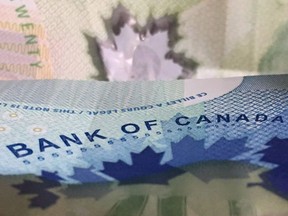 The Bank of Canada will decide today whether to continue raising interest rates, and will issue its latest predictions for the Canadian economy. Canadian bank notes are seen, in Ottawa on Wednesday, September 6, 2017.