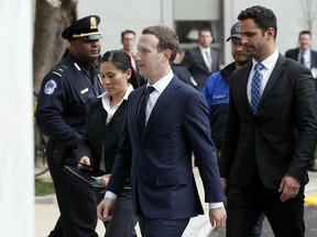 Facebook CEO Mark Zuckerberg, center, arrives to testify before a House Energy and Commerce hearing on Capitol Hill in Washington, Wednesday, April 11, 2018, about the use of Facebook data to target American voters in the 2016 election.