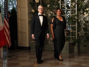 Apple CEO Tim Cook and former EPA administrator Lisa Jackson arrive for a State Dinner with French President Emmanuel Macron and President Donald Trump at the White House, Tuesday, April 24, 2018, in Washington.