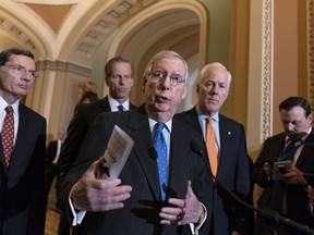 Senate Majority Leader Mitch McConnell, R-Ky., joined from left by, Sen. John Barrasso, R-Wyo., Sen. John Thune, R-S.D., and Majority Whip John Cornyn, R-Texas, speaks with reporters following a closed-door strategy session on Capitol Hill in Washington, Tuesday, April 24, 2018. McConnell urged confirmation for President Donald Trump's nominee for secretary of state, Mike Pompeo.