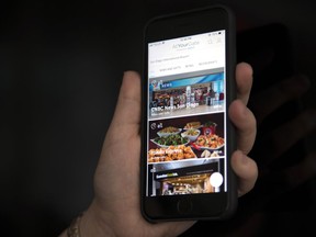 A cell phone displaying the AtYourGate app is shown in this photo illustration in Toronto on Thursday April 5, 2018.