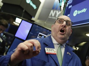 Specialist Peter Giacchi calls out prices to traders during the Spotify IPO, on the floor of the New York Stock Exchange.