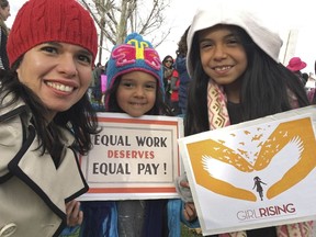 In this Jan. 21, 2017 photo provided by Aileen Rizo,  Rizo, along with her daughters Diana Acosta, 10, center, and Vivan Acosta, 6, right, attend the national Women's March in Fresno, Calif. Relying on women's previous salaries to determine their incomes at new jobs perpetuates longstanding disparities in the wages of men and women and is illegal when it results in higher pay for men, a federal appeals court ruled on Monday, April 9, 2018, in a novel opinion that aims to address the "financial exploitation of working women." The unanimous ruling by an 11-judge panel of the 9th U.S. Circuit Court of Appeals came in the case of a California school employee who learned over lunch with colleagues in 2012 that she made thousands less than her male counterparts. Aileen Rizo took a job as a math consultant in Fresno County in 2009 after working for several years in Arizona.