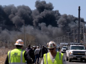 Workers evacuate from an explosion and fire at the Husky Energy oil refinery in Superior, Wisconsin on Thursday.