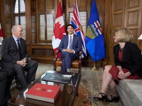 Prime Minister Justin Trudeau, B.C. Premier John Horgan, left, and Alberta Premier Rachel Notley, sit in Trudeau's office on Parliament Hill for a meeting on the deadlock over Kinder Morgan's Trans Mountain pipeline expansion, in Ottawa on Sunday, April 15, 2018.