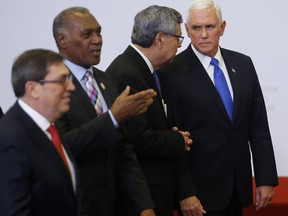 U.S. Vice President Mike Pence, right, speaks with Guatemala's Vice President Jafeth Cabrera after the official photo at the Summit of the Americas in Lima, Peru, Saturday, April 14, 2018.