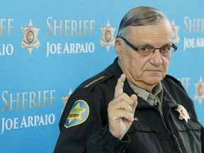 FILE - In this Dec. 18, 2013, file photo, Maricopa County Sheriff Joe Arpaio speaks at a news conference in Phoenix, Arizona. Sen. Jeff Flake's son will seek a new civil trial against  then-Sheriff Arpaio for bringing a now-dismissed criminal case against him in the heat-exhaustion deaths of 21 dogs. Austin Flake lost a lawsuit against Arpaio at a trial in December. His attorney says he'll seek another trial because authorities didn't turn over evidence before trial that would have swayed jurors in his client's favor.