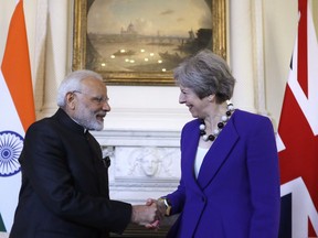 Britain's Prime Minister Theresa May shakes hands with Narendra Modi, the Prime Minister of India during a bilateral meeting at 10 Downing Street in London, Wednesday, April 18, 2018.