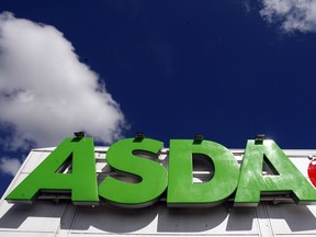 FILE - In this file photo dated Tuesday July 17, 2007, the sign of an Asda store in Wallington, England.  It is reported Monday April 30, 2018, Sainsbury's has agreed a merger deal with Walmart Inc.'s U.K. unit, Asda, for 7.3 billion pounds (dollars 10.1 billion U.S.) in cash and stock in a deal that would create Britain's largest supermarket chain, but the deal will be subject to review by Britain's Competition and Markets Authority.