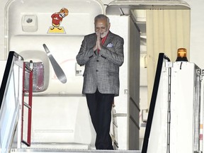 India's Prime Minister Narendra Modi emerges from his plane as he is welcomed on arrival at Arlanda Airport in Stockholm, Sweden, Monday April 16, 2018.