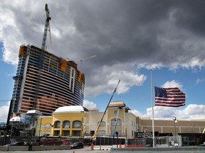 Clouds pass over the Wynn Resorts casino construction site in Everett, Mass., Thursday, April 26, 2018. Massachusetts gambling regulators consider Wynn Resorts' request to remove the name of company founder Steve Wynn, who faces numerous allegations of sexual misconduct, from its state casino license.
