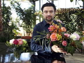 In this March 23, 2018, photo, Shane Pliska, owner of Planterra, a commercial florist and owner of a wedding venue where the decor is all about flowers and plants poses for a photo at his company, in West Bloomfield, Mich. When Hurricane Irma forced Miami International Airport to shut down in September, flower shipments from South America, couldn't arrive. But the floral industry is set up for such contingencies, and distributors quickly arranged for shipments from other parts of the world. Pliska got flowers from Kenya in that case.