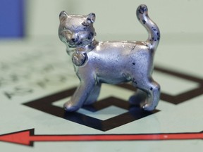 FILE - In this Tuesday, Feb. 5, 2013 file photo, the newest Monopoly token, a cat, rests on the game board at Hasbro Inc. headquarters, in Pawtucket, R.I. Hasbro Inc. (HAS) on Monday, April 23, 2018, reported a first-quarter loss of $112.5 million, after reporting a profit in the same period a year earlier. (