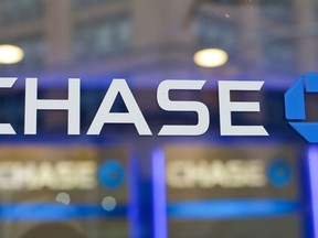 FILE - This Sept. 13, 2014, file photo, shows the Chase bank logo in New York.  The nation's six big Wall Street banks posted record or near record profits in the first quarter, thanks largely to the recently enacted Trump tax law. Combined, the six banks saved at least $3.59 billion in taxes last quarter, according to an Associated Press estimate, Friday, April 20, 2018, using the bank's tax rates going back to 2015.