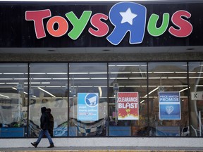 FILE- This Jan. 24, 2018, file photo shows a person walking near the entrance to a Toys R Us store, in Wayne, N.J.  Canada's Fairfax Financial Holding has placed a bid of $300 million to buy Toys R Us's Canadian operations in bankruptcy. According to court papers filed late Thursday, April 19, 2018, the bidder is taking on a role of a "stalking horse" in a court-approved auction set for Monday in New York. That means it could be outbid in the auction if other buyers come in with a higher offer. The bid from Fairfax surpassed the $215 million offer that Isaac Larian, the CEO of privately held toy company MGA Entertainment, made last week.