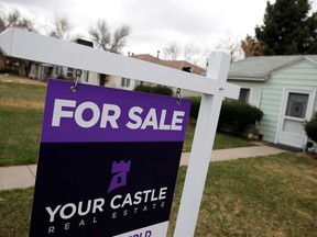 FILE- In this March 28, 2018, file photo, a for sale sign is shown outside a single-family home on the market in Denver. On Monday, April 23, the National Association of Realtors reports on March sales of existing homes.