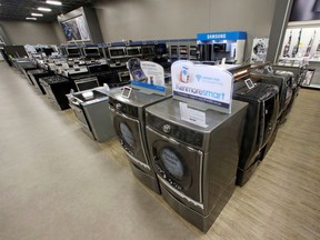 FILE - In this July 20, 2017, file photo, the Kenmore Elite Smart Electric Dryer and Front Load Washer, center, appears on display at a Sears store, in West Jordan, Utah. Private equity firm ESL Investments is offering to buy struggling Sear's Kenmore brand and home improvement unit.