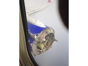 FILE - This Aug. 27, 2016, file photo shows an engine through a window of a Southwest Airlines flight. The flight from New Orleans bound for Orlando, Fla., diverted to Pensacola, Fla., after the pilot detected something had gone wrong with the engine. Over the years, the Dallas-based carrier has paid millions of dollars to settle safety violations, including multiple fines for flying planes that didn't have required repairs. In 2016, the engine on the Southwest jet blew apart over Florida, hurling debris that struck the fuselage and tail. The pilots landed the plane safely, and no one was hurt. (Jeremy Martin via AP, File)