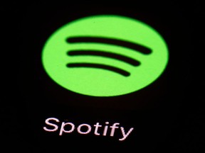 FILE- This March 20, 2018, file photo shows the Spotify app on an iPad in Baltimore. On Tuesday, April 3. music-streaming pioneer Spotify plans an initial public offering of stock.