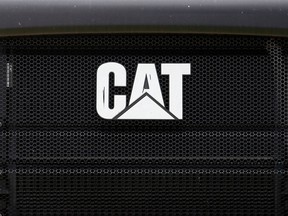 FILE- This July 24, 2017, file photo shows the Caterpillar logo on the front grille of a Caterpillar 725C End Dump truck at a dealer in Miami. Caterpillar Inc. reports earnings Tuesday, April 24, 2018.