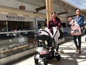 FILE- In this April 9, 2018, file photo shoppers walk in a mall in Salem, N.H. On Tuesday, April 25, the Conference Board releases its April index on U.S. consumer confidence.