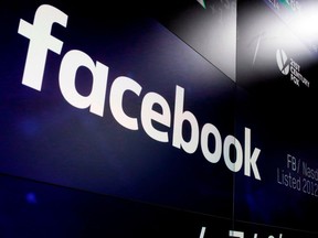 FILE - In this March 29, 2018, file photo, the logo for Facebook appears on screens at the Nasdaq MarketSite in New York's Times Square. For the first time, Facebook is making public, on Tuesday, April 24, its detailed guidelines for determining what it will and won't allow on its service.
