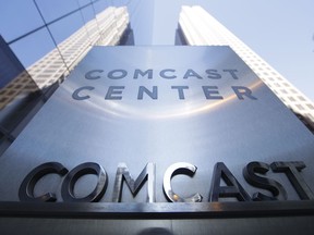 FILE- This March 29, 2017, file photo shows a sign outside the Comcast Center in Philadelphia. Comcast Corp. reports earnings Wednesday, April 25, 2018.