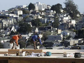 In this March 28, 2018 photo, a construction crew works on a roof in San Francisco. On Wednesday, April 4, the Institute for Supply Management, a trade group of purchasing managers, issues its index of non-manufacturing activity for March.