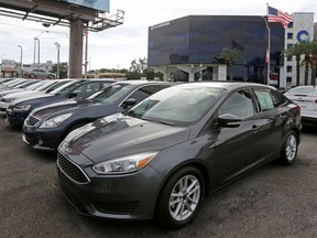 FILE- In this Jan. 17, 2017, file photo, certified pre-owned vehicles sit on display at an auto dealership in Miami. Used vehicle sales hit 39.2 million vehicles in 2017, more than double the number of new automobiles sold, according to the Edmunds.com auto website.
