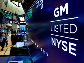 FILE- In this April 23, 2018, file photo, the logo for General Motors appears above a trading post on the floor of the New York Stock Exchange. General Motors Co. reports earns on Thursday, April 26.