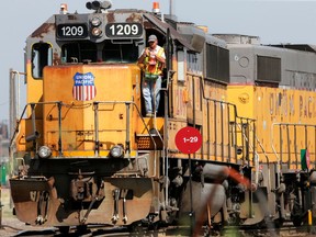 FILE- In this July 20, 2017, file photo, a Union Pacific employee is seen on board a locomotive in a rail yard in Council Bluffs, Iowa. Union Pacific Corp. reports earns on Thursday, April 26, 2018.