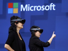 FILE- In this May 11, 2017, file photo, members of a design team at Cirque du Soleil demonstrate use of Microsoft's HoloLens device in helping to virtually design a set at the Microsoft Build 2017 developers conference in Seattle.Microsoft Corp. reports earns on Thursday, April 26, 2018.