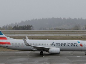 FILE- In this April 13, 2018, file photo, an American Airlines plane taxis Friday, April 13, 2018, at the Seattle-Tacoma International Airport in Seattle. American Airlines reports earns on Thursday, April 26.