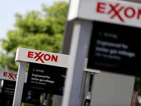 FILE - This April 25, 2017, file photo, shows Exxon service station signs in Nashville, Tenn. Exxon Mobil Corp. reports earnings Friday, April 27, 2018.