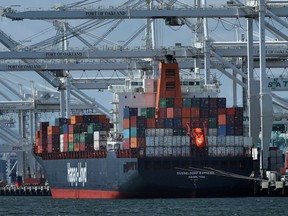 FILE- In this April 12, 2018, file photo, a container ship is unloaded at the Port of Oakland in Oakland, Calif. The International Monetary Fund has upgraded its economic outlook for the United States in 2018 and foresees a strong year for the global economy as well. The IMF predicts that the U.S. economy will grow 2.9 percent this year, up from the 2.7 percent it had forecast in January and up from the 2.3 percent growth the economy achieved last year.