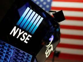 FILE - In this Dec. 27, 2017, file photo, a logo for the New York Stock Exchange is displayed above the trading floor. On Wednesday, April 4, 2018, US stocks open sharply lower on escalating US-China trade dispute.