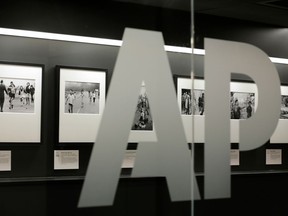 FILE- In this April 18, 2017, file photo Associated Press photographs are displayed at the AP headquarters in New York. The AP reports earnings Wednesday, April 25, 2018.