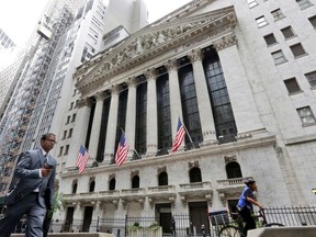 FILE- In this Oct. 24, 2017, file photo, people pass the New York Stock Exchange. The U.S. stock market opens at 9:30 a.m. EDT on Thursday, April 26, 2018.