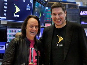T-Mobile CEO John Legere, left, and Sprint CEO Marcelo Claure pose for photos on the floor of the New York Stock Exchange, Monday, April 30, 2018. To gain approval for their $26.5 billion merger agreement, T-Mobile and Sprint aim to convince antitrust regulators that there is plenty of competition for wireless service beyond Verizon and AT&T.
