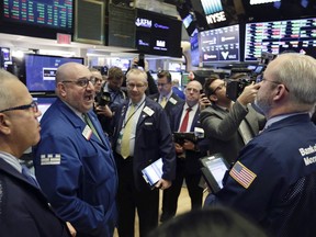 Specialist Peter Giacchi, left, calls out prices before Spotify's IPO on the floor of the New York Stock Exchange, Tuesday, April 3, 2018. The Swedish company will make its stock market debut Tuesday, casting a spotlight on its early lead in music streaming.
