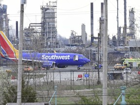 A Southwest Airlines plane sits on the runway at the Philadelphia International Airport after it made an emergency landing in Philadelphia, on Tuesday, April 17, 2018.  The Federal Aviation Administration says the flight from New York to Dallas made an emergency landing after the crew reported damage to one of the engines, as well as the fuselage and at least one window.